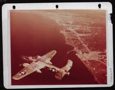 Thumbnail for ␀ > High Angle View Of A B-25, Bearing A Triumphant Slogan 'Finito Benito, Next Hirohito', Flying Over The Gulf Of Naples.