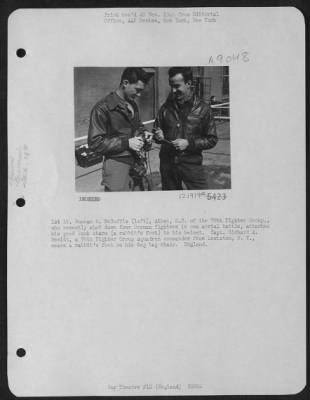 Thumbnail for Consolidated > 1St Lt. Duncan M. Mcduffie (Left) Aiken, S.C., Of The 78Th Fighter Group, Who Recently Shot Down Four German Fighters In One Aerial Battle, Attaches His Good Luck Charm (A Rabbit'S Foot) To His Helmet.  Capt. Richard A. Hewitt, A 78Th Fighter Group Squadr