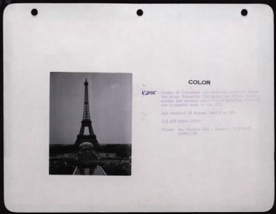 Thumbnail for Celebrations > Crowds Of Frenchmen And American Soldiers Watch The Plane Formation Flying By The Eiffel Tower, During The Outdoor Exposition Displaying Aircraft And Equipment Used In The Eto.