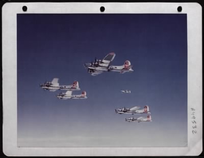 Boeing > Hovering Close To Its Charges, A P-51 Of The 8Th Air Force Practices With A Formation Of B-17S Over England.