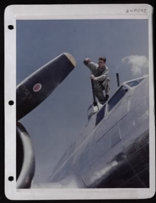 ␀ > Cpl. James E. Dunbar, Gunnery Mechanic, Runs A Patch Thru Top Turret Guns Of A Boeing B-17 At A Base In England.