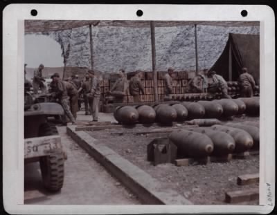 ␀ > Ordnance Men Loading 100 Lb. Demolition Bombs Onto Trailers. England.