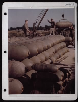 ␀ > Ordnance Men Load 2000 Lb. Bombs On A Trailer At A Base Somewhere In England.