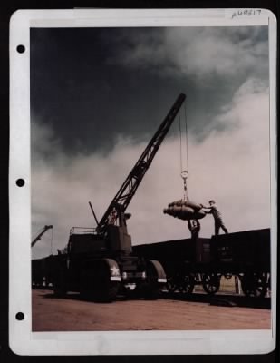 ␀ > Ordance Crew Unloading Bombs From British 'Wagon' To Be Stacked In Bomb Revetment. 8Th Af.