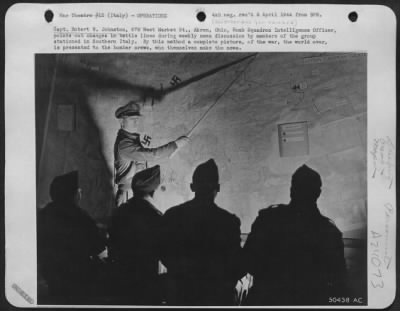 Consolidated > Capt. Robert B. Johnston, 676 West Market St., Akron, Ohio, Bomb Squadron Intelligence Officer, points out changes in battle lines during weekly news discussion by members of the group stationed in Southern Italy. By this method a complete picture