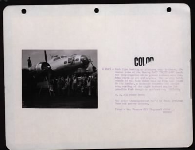 Bomber > Back From Bombing An Airdrome Near Bordeaux, The Combat Crew Of The Boeing B-17 'Patsy Ann' Heads For Interrogation While Ground Crewmen Make Routine Check On Oil And Engine. Man On Wing Holds Nozzle Of Oil Hose Which Runs Up From Tank Truck. On The Ladde