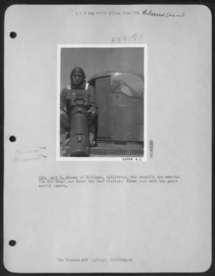 Consolidated > Sgt. Jack N. Storey of Williams, California, who recently was awarded the Air Medal and First Oak Leaf Cluster. Shown here with his giant aerial camera.