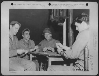 Consolidated > At a landing Ground on Anzio Beachhead in Italy, playing cards is practically the only form of recreation available to members of an aviation engineers outfit charged with the job of maintaining an airfield on the beachhead south of Rome. In the