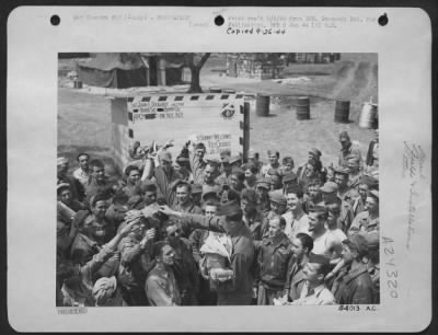 Thumbnail for Consolidated > Mail call for members of this Consolidated B-24 Liberator group of the 15th AAF is held in front of this unusual mailroom, built at their base in Southern Italy.