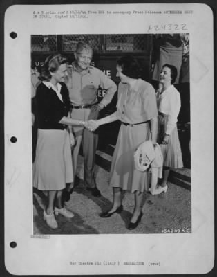 Thumbnail for Consolidated > Somewhere in Italy, Katherine Cornell meets Madeleine Carroll. Behind them is the bus in which Miss Cornell's troupe is touring Italy to present "The Barretts of Wimpole Street" for the armed forces. Miss Carroll left Hollywood to become a Red Cross