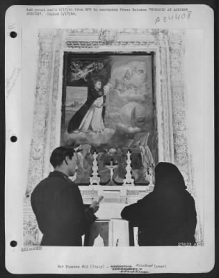 Thumbnail for Consolidated > WORSHIP AT ANCIENT SHRINE--An American soldier, Sgt. Charles Langeler, 410 Eleanor St. Grand Rapids, Mich. And an unnamed Italian woman, pray before a beautiful and ancient shrine in the Church of the Holy Rosary at Manduria, on the heel of the