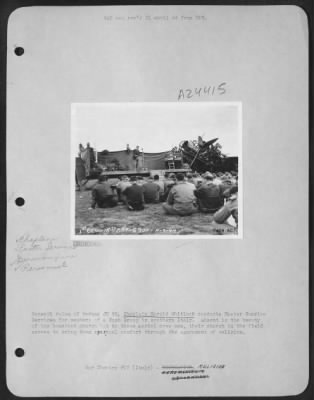 Consolidated > Beneath ruins of German JU 88, Chaplain Harold Whitlock conducts Easter Sunrise Services for members of a Bomb Group in southern Italy. Absent is the beauty of the homeland church but to these aerial crew men, their church in the field serves to