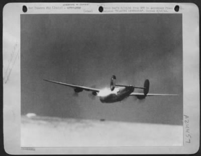 Thumbnail for Consolidated > BLAZING LIBERATOR. Ablazing B-24 Liberator of the U.S. Army 15th Air Force, Mediterranean Allied Air Forces, fights its way home from the target against terrific odds. A few seconds after this picture was taken, the left half of the wing tore off