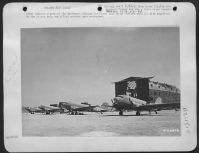 Thumbnail for Consolidated > Troop carrier planes of the Northwest African Air Force land on an Italian Airfield with supplies. On the return trip the allied wounded were evacuated.