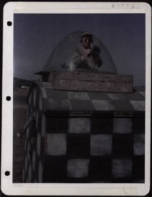 Thumbnail for NAGA Head Hunters > Cpl. Joseph F. Fox, Star City, Ind., In A Salvaged B-17 Plexiglass Nose At A Base In England, Flashes The 'Go Light' To Ground Traffic Crossing The Runway.