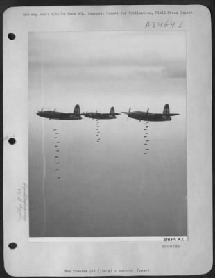 Thumbnail for Consolidated > On their way from the bomb bays of these Martin B-26 Marauders of the 1st Tactical Air Force, are these high explosive bombs that will find their mark on bridges and railway yards that supply that Hun without a route to maintain his troops on the