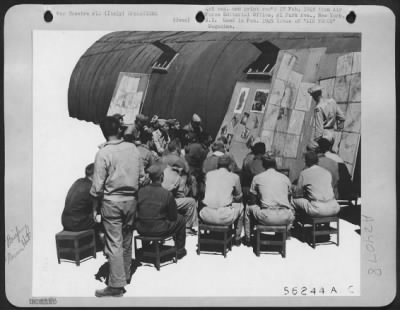 Thumbnail for Consolidated > With Nissen Hut For Backdrop, Lockheed P-38 Lightning Pilots Are Briefed For Mission Escorting Heavies.  Italy.