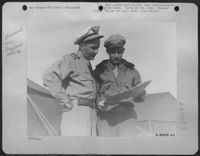 Consolidated > Left Lt. Colonel Nero Moura, C.O. Of The First Brazilian Fighter Squadron, Discussing The Day'S Target With Capt. John W. Buyers, Liaison Officer Of The Squadron.  The Capt. Was Born In Brazil, Where His Parents Ran A Methodist Mission.