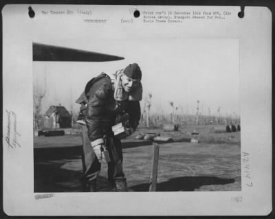 Thumbnail for Consolidated > Lt. Francis J. Burgess Of 716 N. Irving Blvd., Los Angeles, California Loads His Camera Equipment On A Plane For One Of The 12Th Air Force Combat Camera Unit'S Many Jobs Of Recording The Air War Against The Nazis On Newsreel.