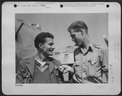 Thumbnail for Consolidated > Left, Lt. Robert Duncan, 521 West Ormsoy, Louisville, Ky, Sports A Rumanian Air Force Wing, Which Lt. Gerald B. Elliot Of Austin Texas Is Examining.  Both These Men Were Among The More Than 1,000 American Airmen Brought Back To Italy When Rumania Surrende