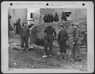 Consolidated > At A Fifth Army Division Prisoner Of War Cage German Prisoners Are Ordered To Remove All Personal Belongings From Their Pockets.  One Superman Drops A Copy Of  "Frontpost" On The Ground.  Italy.