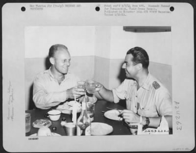 Thumbnail for Consolidated > Lt. Colonel James A. Gunn Iii Of 1522 Texas Street, San Antonio, Texas (Left) Who Arranged The Mass Evacuation Of Over 1,000 Former Hun Prisoners From Rumania, Is Shown Here Drinking A Toast To Capt. Bazu Cantacuzino, A Rumania Pilot Converted To The Alli