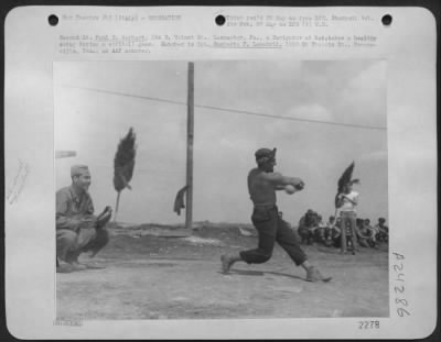 Thumbnail for Consolidated > 2Nd Lt. Paul E. Gerhart, 104 E. Walnut St., Lancaster, Pa., A Navigator At Bat, Takes A Healthy Swing During A Softball Game.  Catcher Is Cpl. Humberto T. Lamadrid, 1222 St. Francis St., Brownsville, Tex., An Aaf Armorer.