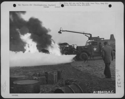 Thumbnail for Consolidated > Working Quickly And Efficiently, With Up-To-Date Equipment, Fire-Fighters Of The 91St Bomb Group At Bassingboure, England, Fight Hazardous Flames Which Enveloped A Crashed Boeing B-17 "Flying Fortress" And Threatened Other Aircraft Nearby.  With Modern Eq