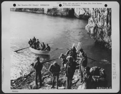 Thumbnail for Consolidated > Two American Red Cross Girls Join 20 War-Weary Youths Of The 15Th Army Air Force On Tour Of The Famous Grottoes Along The Italian Seacoast.  At The Mouth Of The Subterranean Caves, The Boats Unloaded And The Party Proceeded By Foot Through The Precarious