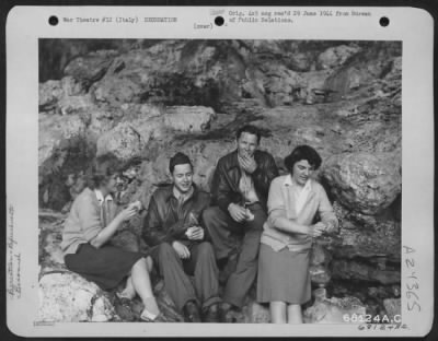 Thumbnail for Consolidated > Two American Red Cross Girsl Joined 20 War-Weary Youths Of The 15Th Army Air Force On A Tour Of The Famous Grottoes Along The Italian Seacoast.  After A Half-Hour, The Mud-Splattered Hikers Found The Grotto Entrance, Where The Girls Served Tasty Sandwiche