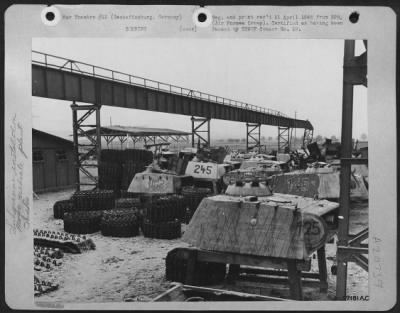 Thumbnail for Consolidated > Tank Treads And Panther Tank Turrets Were Stacked In A Storage Yard Adjacent To The Production Line.  The Rails For The Overhead Crane, Used To Lift And Transport These Heavy Parts To The Main Assembly Line, Have Been Knocked Out Of Line And Partially Des