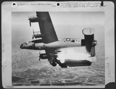 Consolidated > Liberator Over Italy - After Bombing In Support Of The 8Th Army Drive In Northern Italy, This B-24 Liberator Of The U.S. Army 15Th Air Force Has Been Hit By Flak And The Force Of The Explosion Has Crumpled The Wing.  The Big Plane Caught Fire And Plunged