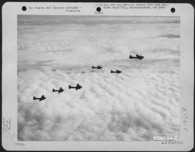 Thumbnail for Consolidated > Boeing B-17 Flying Fortresses Of The 381St Bomb Group En Route To Bomb Enemy Installations Somewhere In Europe, Are Silhouetted Against A Bank Of Fleecy Clouds.