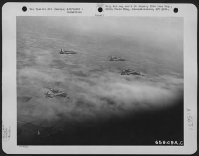 Thumbnail for Consolidated > Boeing B-17 "Flying Fortress" Of The 381St Bomb Group Wing Their Way Over Checkerboard Landscape, En Route To Bomb Enemy Installations In Europe.