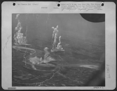 Consolidated > Fantastic Towers Of Smoke Rise From Anti-Aircraft Positions Neutralized By A Force Of 57Th Bomb Wing North American B-25 Mitchells.  Other Mitchell Bombers Successfully Attacked A Motor Transport Ferry That The Flak Guns Were Defending.  The Target Is In