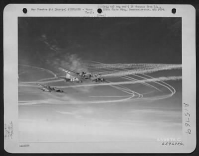 Thumbnail for Consolidated > Boeing B-17 Flying Fortresses Of The 381St Bomb Group, En Route To Bomb Enemy Installations In Europe, Leave Their Trails In The Sky.