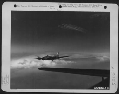 Thumbnail for Consolidated > Boeing B-17 Flying Fortresses Of The 381St Bomb Group Wings Its Way Toward The Target Somewhere In Europe.  Far In The Distance Two Formations Leave Vapor Trails Streaming Behind Them As They Roar Onward.