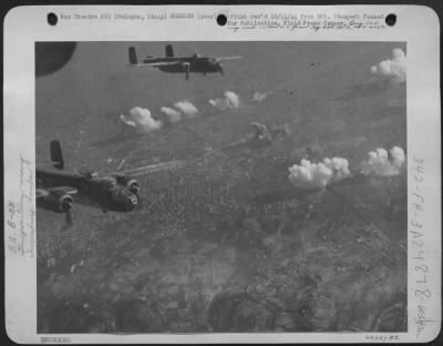 Thumbnail for Consolidated > Low-Flying Tactical Air Force North American B-25 Mitchells Bust Up The Bologna, Motor Transport Area And Silence Defending Gun Positions.  The White Smoke Puffs Are From The Gun Emplacements, Which Were Plastered With Incendiary Bombs.  Italy.