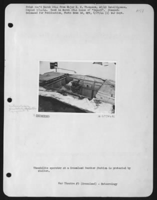 General > Theodolite Operator At A Greenland Weather Station Is Protected By Shelter. Print Received March 1944 From Major E.K. Thompson, Ac /As. Intelligence.  Copied March 14, 1944.  Used In March 1944 Issue Of "Impact."  Stamped: "Released For Publication, Photo