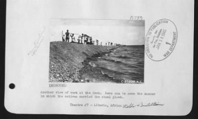 Thumbnail for General > Another view of work at the dock.  Here can be seen the manner in which the natives carried the steel plank.