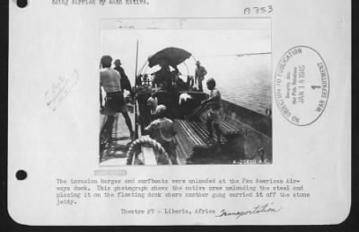 Thumbnail for General > The invasion barges and surfboats were unloaded at the Pan American Airways dock.  This photograph shows the native crew unloading the steel and placing it on the floating dock where another gang carried it off the stone jetty.