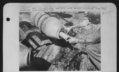 Thumbnail for General > Sgt William N. Bottom, Uniontown, Pa., inserts an igniter into a 500-lb demolition bomb which will be dropped by a B-29 of the U.S. Army 20th Air force. After this is inserted, a bursting charge is placed into the bomb. Lower photo shows