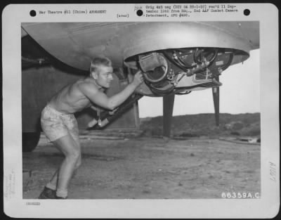 General > S/Sgt. Ralph L. Burnett Of Waukegan, Ill. Checking Forward Lower Gun Turret Of A Boeing B-29, 468Th Bomb Group, Xx Bomber Command, Prior To Mission 9 To Anshan, Manchuria.  China.