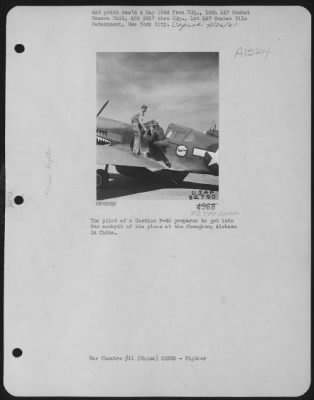 Fighter > The Pilot Of A Curtiss P-40 Prepares To Get Into The Cockpit Of His Plane At Chengkung Airbase In China.