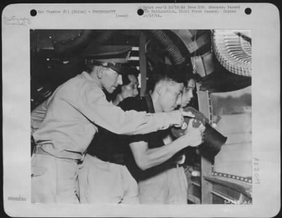 Thumbnail for Cameras > CHINA Capt. Azra Judd is Wing Photo Officer. Here he instructs Sub-Lt. Wei-Ta-Ming; Sgt. Fu-Yiu-Lum; and Sgt. Yen Shi in camera mounting. This officer goes on many bombing missions; makes pictures for Intelligence; checks automatic gun-cameras