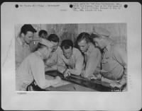 Thumbnail for China-Pilot and S-2 Officer watch as photo-interpreters pick negatives for rush printing for first phase interpretation. - Page 1