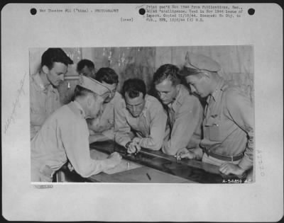 Thumbnail for Operations & Mapping > China-Pilot and S-2 Officer watch as photo-interpreters pick negatives for rush printing for first phase interpretation.