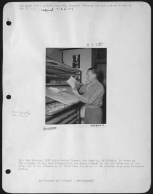 Thumbnail for Processing > Cpl. Ted Brunner, 1333 South Norton Street, Los Angeles, Caliofrnia, is shown at the homemade drying rack (cheesecloth and scrap lumber) he and the other men of the photo lab of the Liberators of China have rigged up in the absence