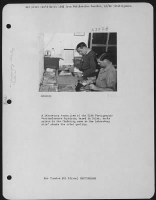 Thumbnail for Processing > A Laboratory Technician Of The 21St Photographic Reconnaissance Squadron, Based In China, Sorts Prints In The Finishing Room As The Laboratory Chief Checks The Print Quality.