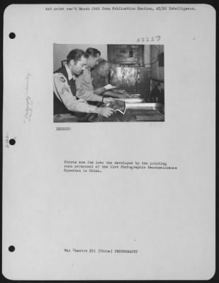 Thumbnail for Processing > Prints Are Fed Into The Developer By The Printing Room Personnel Of The 21St Photographic Reconnaissance Squadron In China.